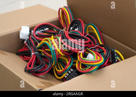 Perm, Russia - June 29, 2023: sets of multi-colored cables with connectors in a packing box Stock Photo