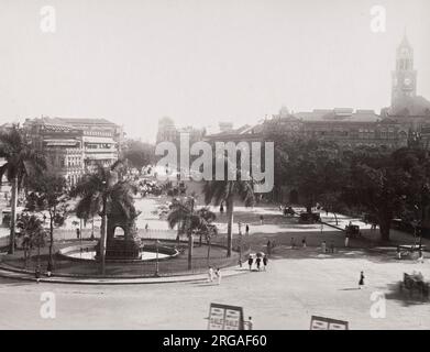 19th century vintage photograph: street view Bombay, Mumbai, India. Flora Fountain is located at the Hutatma Chowk is an ornamentally sculpted architectural heritage monument located at the southern end of the historic Dadabhai Naoroji Road. Stock Photo