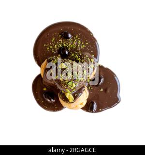 Cream puff with custard cream covered with melted chocolate isolated on white background Stock Photo