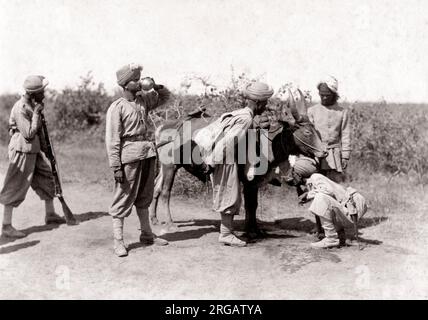 c. 1880s India - soldiers getting water from a bheestie water carrier Stock Photo