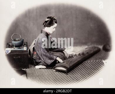 1860's Japan - portrait of a young woman musician playing a koto Felice or Felix Beato (1832 - 29 January 1909),  Italian-British photographer working mostly in India, Japan, China Stock Photo