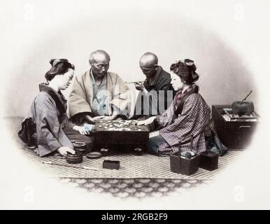 1860's Japan - portrait of a group of men and women playing Go board game Felice or Felix Beato (1832 - 29 January 1909),  Italian-British photographer working mostly in India, Japan, China Stock Photo