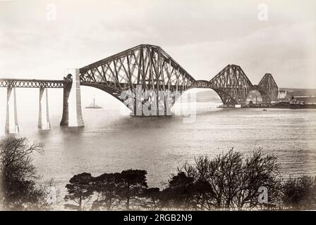 19th century vintage photograph: view of the railway bridge over the Firth of Forth, Scotland, seen from the south bank of the river. c.1890's. Stock Photo