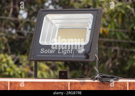 Reflector powered by solar panels fixed on the wall. Stock Photo