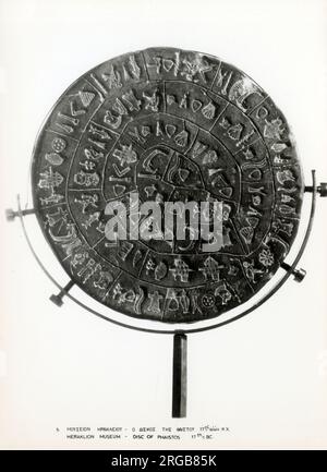 The Phaistos Disc (also spelled Phaistos Disk, Phaestos Disc) is a disk of fired clay from the Minoan palace of Phaistos on the island of Crete, possibly dating to the middle or late Minoan Bronze Age (second millennium BC). The disk is about 15 cm (5.9 in) in diameter and covered on both sides with a spiral of stamped symbols. The Phaistos Disc was discovered in the Minoan palace-site of Phaistos, near Hagia Triada, on the south coast of Crete. Stock Photo