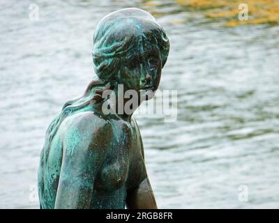 Copenhagen, Denmark - Close up detail of the  Little Mermaid  symbol of the Danish capital, statue from 1913  at the entrance of Copenhagen harbor, in Stock Photo
