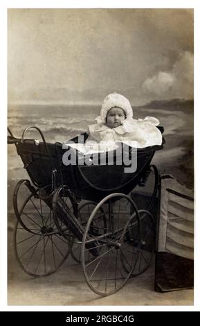 A very bonny baby in an extremely fine late Victorian / very early Edwardian perambulator. Stock Photo