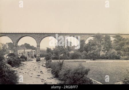Railway viaduct, River Greta and mill buildings, Ingleton, North Yorkshire Stock Photo