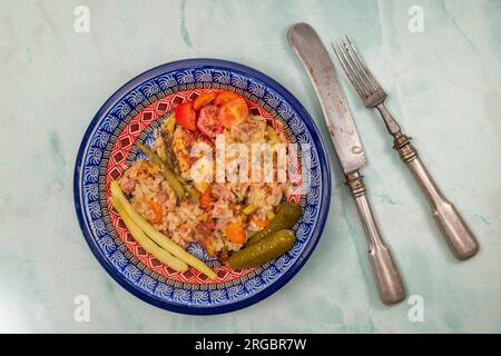 Old historic knife nad fork with color plate with turkey meat fresh risotto Stock Photo