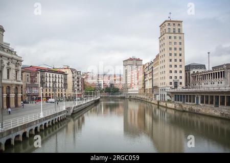 Bilbao Spain - 07 05 2021: Panoramic exterior view at the Bilbao downtown city, Nervión river and river banks and iconic buildings Stock Photo