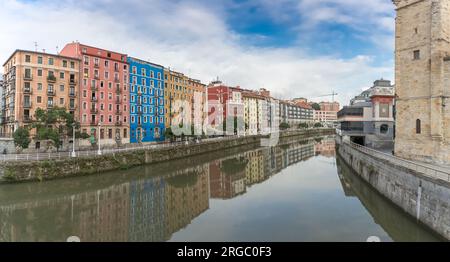 Bilbao Spain - 07 05 2021: Panoramic exterior view at the Bilbao downtown city, Nervión river and river banks and iconic buildings Stock Photo