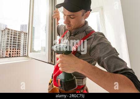 window installation wizard configures window closing Stock Photo