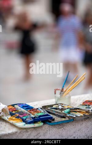 selection of artists equipment for painting watercolours on a wall with brushes and paints Stock Photo