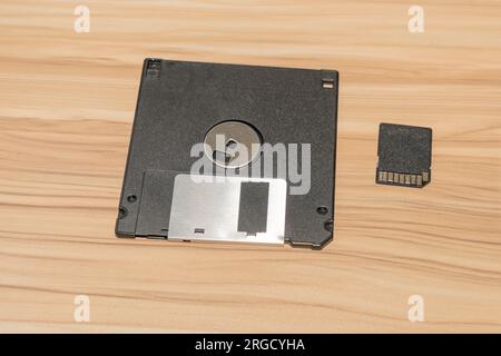 Photography of varios media storage device on brown wood background. Stock Photo