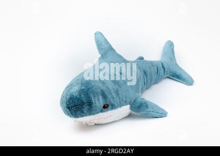 Nova Bana, Slovakia - August, 7, 2023 : Blahaj, Ikea plush toy made of recycled polyester. Stuffed Animal Toy Blue shark on white background. Stock Photo