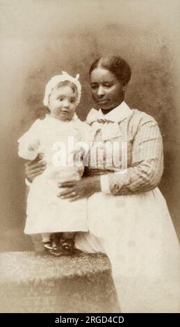 Little white toddler with her black nanny - Chicago, USA Stock Photo