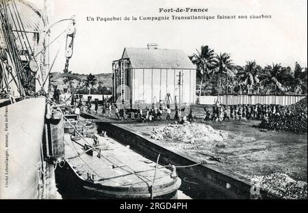 Martinique - Fort-de-France - A Packet boat taking on coal. Stock Photo