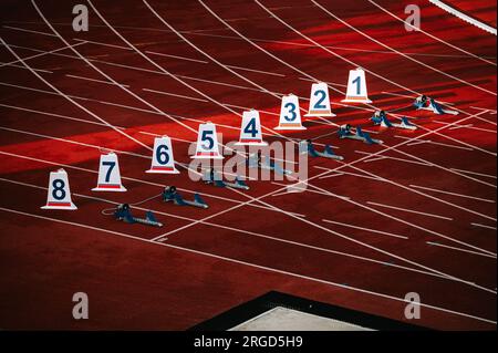 Starting numbers on athletics track. Professional Sprint race. Colorful photo for for Worlds in Budapest and Games in Paris Stock Photo