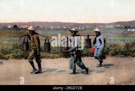 WW1 - Vietnamese Soldiers at Thessaloniki, Greece. Almost 100,000 Vietnamese were conscripts and went to Europe to fight and serve on the French battlefront, or work as labourers (or water carriers as shown here). Several battalions fought and suffered loss of lives at the Somme and Picardy, while others were deployed at Verdun, the Chemin des Dames, and in Champagne. Vietnamese troops also served in the Balkans and the Middle East. Note the non la (leaf hats) Stock Photo