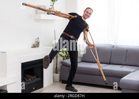 Young leg injured man with crutches Stock Photo