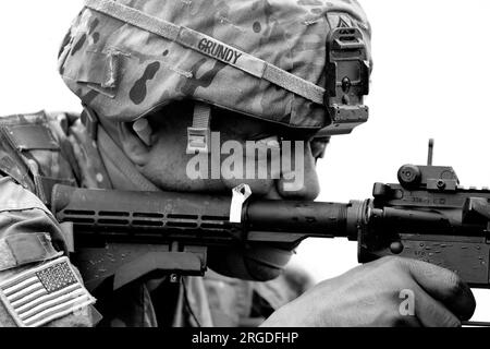 Indiana, USA. 28th July, 2023. Sgt. 1st Class Robert Grundy fires at a pop-up target during Operation Pershing Strike at Camp Atterbury, Ind., July 28, 2023. Pershing Strike is a total army force exercise between the Army Reserve, National Guard and active-duty soldiers. Credit: U.S. Army/ZUMA Press Wire/ZUMAPRESS.com/Alamy Live News Stock Photo