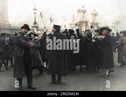 Women waving Union flags and cheering on Armistice Day 1918 at the end of World War One. Stock Photo