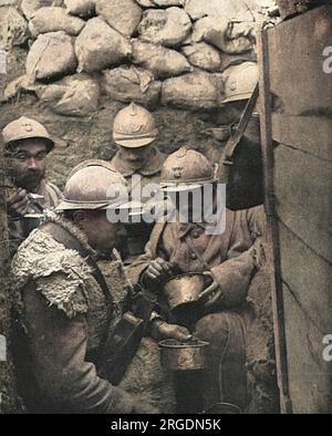 Dinner-time for soldiers in a corner of a fire-trench on the French front in the Argonne. The caption reads: 'The clockwork regularity of the French culinary arrangements at the front, and the food-supply system to the troops in the battlefield region, have been repeatedly remarked on as a wonder of French war organisation'. Stock Photo