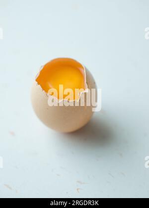 Cracked egg on white Stock Photo