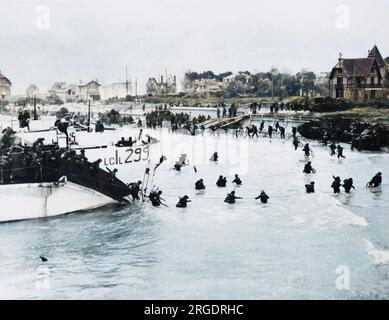 British and Canadian 3rd Division troops land at Juno Beach. D-Day began on June 6th, 1944 at 6:30am and was conducted in two assault phases û the air assault landing of allied troops followed by an amphibious assault by infantry. The Normandy landings were the largest single-day amphibious actions ever undertaken, involving close to 400,000 military and naval personnel. Stock Photo