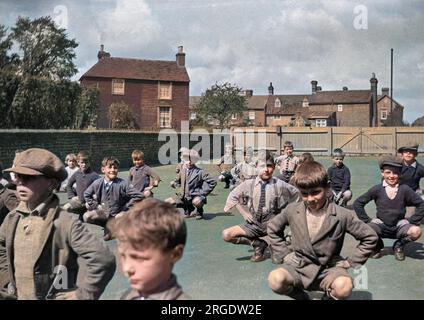 Boys exercising in a school playground. Stock Photo