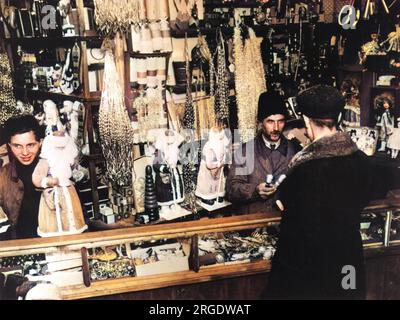 The interior of a 1928 Moscow shop laden with outlandish Christmas decorations available for purchase. Stock Photo