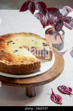 plum cake in asian style minimalism, soft light, white linen tablecloth Stock Photo