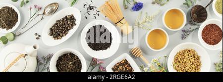 Assortment of dry tea in white ceramic bowls. Matcha, rooibos, black, green, herbal mix, masala and camomile tea. Top view, flat lay, banner Stock Photo