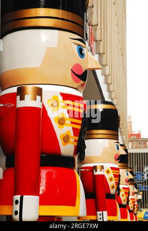 A row of Christmas nutcrackers dressed like soldiers line a business building in New York City during the holiday season Stock Photo