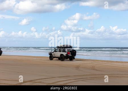 75 mile beach Fraser Island K'gari, 4WD vehicle driving along the sand road highway,Queensland,Australia Stock Photo