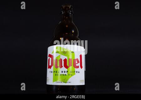 Picture of a bottle with the logo of Duvel Tripel Hop Citra on a label. Duvel Moortgat Brewery is a Flemish family-controlled brewery founded in 1871 Stock Photo