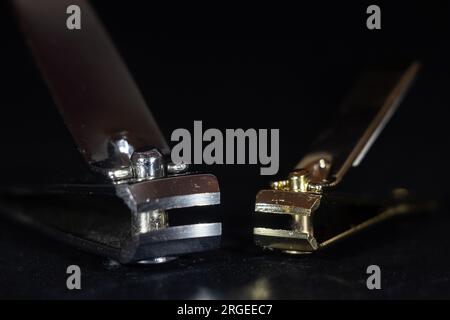 Picture of nail clippers on a black background. A nail clipper (also called nail clippers, a nail trimmer, a nail cutter or nipper type) is a hand too Stock Photo