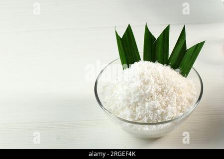 Grated Coconut with Pandan Leaf on White Table Stock Photo