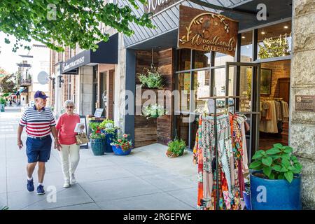 Hendersonville North Carolina,Main Street,clothing rack,man men male,woman women lady female,adults residents couple,senior citizen pensioner,retired Stock Photo