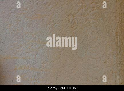 The concrete surface is pale yellow, faded and old. Stock Photo