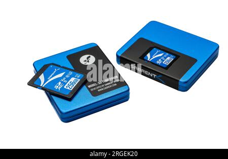 NISSWA, MN – 1 AUG 2023: Closeup of a Sabrent brand 256 GB SD Card on top of one of two cases, isolated on white. Stock Photo