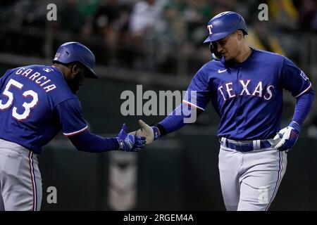 Texas Rangers' Corey Seager, Ezequiel Duran, Marcus Semien, Nathaniel Lowe  and Adolis Garcia, from left, celebrate the team's 4-2 win in a baseball  game against the Philadelphia Phillies, Wednesday, June 22, 2022