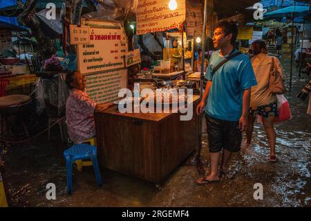 Thais still selling their goods during the flood at dusk. Tha Chang Pier, The Chao Phraya River, Bangkok, Thailand. Oct., 2011. © Kraig Lieb Stock Photo