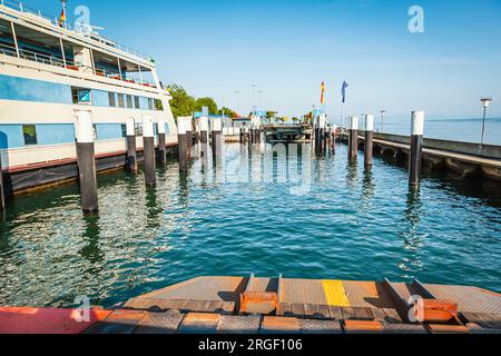 Ferry coming to port for loading or unloading by a port pier Stock Photo