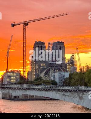 Paris, France. 08th Aug, 2023. Sunset on Notre-Dame Cathedral under reconstruction works after the dramatic fire of April 15, 2019. Paris, France on August 8, 2023. Photo by Christophe Geyres/ABACAPRESS.COM Credit: Abaca Press/Alamy Live News Stock Photo