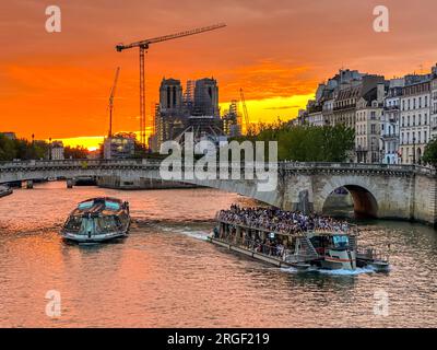 Paris, France. 08th Aug, 2023. Sunset on Notre-Dame Cathedral under reconstruction works after the dramatic fire of April 15, 2019. Paris, France on August 8, 2023. Photo by Christophe Geyres/ABACAPRESS.COM Credit: Abaca Press/Alamy Live News Stock Photo
