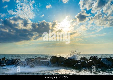 sunset over the sea with waves Stock Photo