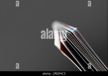 Closeup of open magazine pages on dark background. Shallow depth of focus Stock Photo