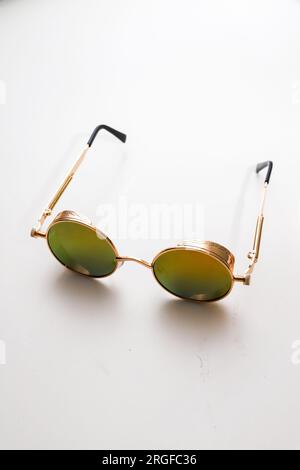 Elegant golden round isolated sunglasses on white Stock Photo