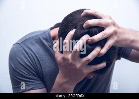 Man holding his head for having breakdown or panic attack Stock Photo